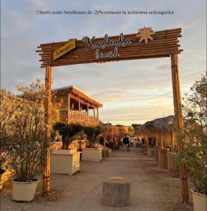 a sign for a garden center with potted plants at Club Waves - Vama Veche in Vama Veche