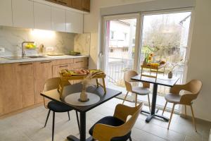 a kitchen with a table and chairs in a kitchen at Double Room with Breakfast Free Parking and EV ready in Postojna
