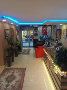 a lobby with a room with plants and a blue light at Efendi Hotel old town special category in Istanbul