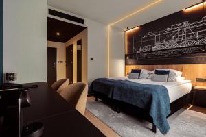 a hotel room with a bed and a table and chairs at Butikowy Hotel M23 Katowice Centrum in Katowice