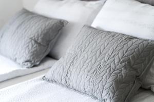 a white bed with two pillows on it at Double Room with Breakfast Free Parking and EV ready in Postojna