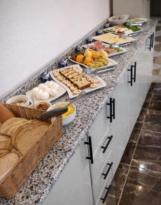 a buffet line with many plates of food on it at Ali Baba Hotel in Luxor