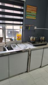 a kitchen with a sink and some pots and pans at MatiinJannah Homestay Arau in Arau
