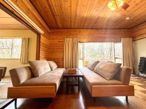 a living room with a couch and a table at SSK Mountain Base in Tsumagoi