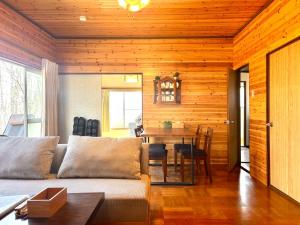 a living room with a couch and a table at SSK Mountain Base in Tsumagoi