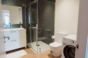 a bathroom with a shower and a toilet and a sink at Apartamento Saiáns in Oya +58 photos
