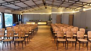 an empty room with rows of chairs and tables at The Jungle Walker Resort in Rishīkesh +95 photos