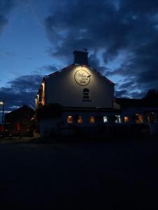 a building with a sign on the side of it at night at The White Swan in Leeds +14 photos