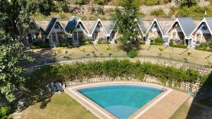 an overhead view of a swimming pool in front of a house at The Jungle Walker Resort in Rishīkesh