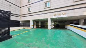 an empty swimming pool in front of a building at Osan J Hotel in Osan