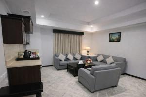 a living room with two couches and a table at Carawan Al Khaleej Hotel Olaya in Riyadh +25 photos