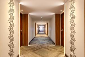 a hallway with a mirror on the wall at Wienglakor Hotel Lampang in Lampang