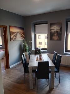 a dining room with a table and chairs at Flensburg City 6 1 in Flensburg +15 photos