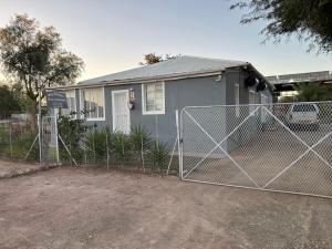 a house with a fence in front of it at Maltahöhe Self Catering in Maltahöhe