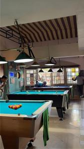a billiard room with two pool tables in it at Hotel VATOLA in Antsirabe