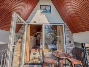 a small room with a table and chairs and a room with a window at The Jungle Walker Resort in Rishīkesh