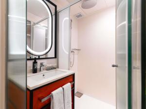 a bathroom with a sink and a mirror at ibis Styles Ambassador Seoul Myeong-dong in Seoul