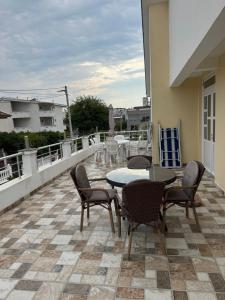 a patio with a table and chairs on a balcony at Villa Mane in Donji Štoj