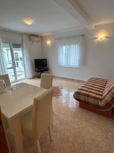 a living room with a table and chairs and a couch at Villa Mane in Donji Štoj