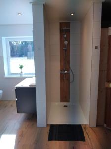a bathroom with a shower and a sink at Ferienhäuser Eggers in Bispingen +43 photos