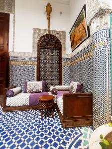 a living room with a couch and a table at Riad Benkirane Fes Medina in Fez
