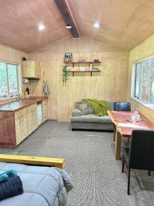a living room with a couch and a table at Secluded Redwood Cabin in Ashley Clinton