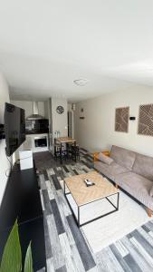 a living room with a couch and a table at Robert in Verdun-sur-Meuse
