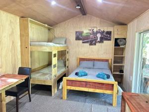 a bedroom with a bunk bed and a desk at Secluded Redwood Cabin in Ashley Clinton