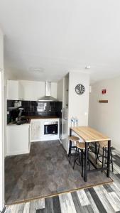 a kitchen with a wooden table in a room at Robert in Verdun-sur-Meuse