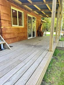 a porch of a house with a wooden deck at Secluded Redwood Cabin in Ashley Clinton +10 photos