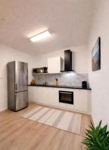 a kitchen with a stainless steel refrigerator at Apartment 3 Sea Centrum Stavanger in Stavanger +11 photos
