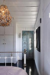 a room with a bed and a door at Bushy Summers - A Nurturing Bayside Shack in Strahan +32 photos