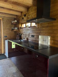 a kitchen with a sink and a stove at Green Village House in Ganna