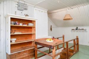 a kitchen with a wooden table in a room at Charming Farmhouse in Gammelbo