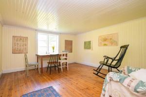 a living room with a table and chairs in it at Charming Farmhouse in Gammelbo
