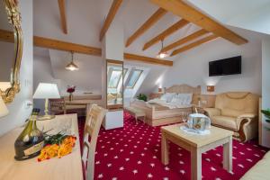 a living room with a couch and a table at Hotel Planinka in Ljubno