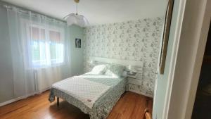 a small bedroom with a bed and a window at La Maison in Le Mas-dʼAzil