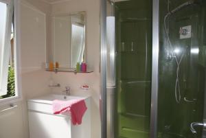 a bathroom with a sink and a shower at Camping Tikayan Clau Mar Jo - Maeva in Bormes-les-Mimosas +15 photos