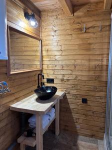a bathroom with a sink in a wooden wall at Green Village House in Ganna +29 photos