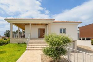 a house with a staircase in front of it at Mirador House in Vila Garcia