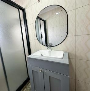 a bathroom with a sink and a mirror at The Residence in Lilongwe +12 photos