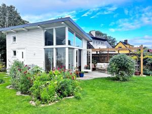 a white house with a patio and a yard at Harbor Breeze & Garden Peace in Åhus