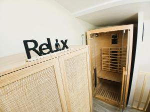 a wooden cabinet with a rx sign on top at L Oasis Cosy Sauna Privé et Jardin in Bouguenais