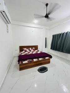 a bedroom with a bed in the middle of a room at Skyline Hotel & Banquet in Rewa