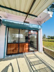 a glass door of a house with a roof at Skyline Hotel & Banquet in Rewa