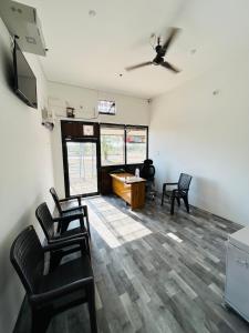 a living room with two chairs and a table at Skyline Hotel & Banquet in Rewa