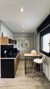 a kitchen with a table and a table and chairs at Silia Villas in Ormos Panagias