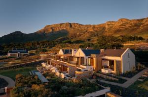 an aerial view of a house with a mountain in the background at The Alexander Estate in Noordhoek