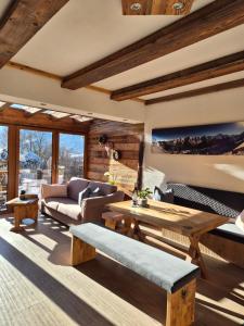 a living room with a couch and a table at Chalet Gletscherblick Stubai in Mieders