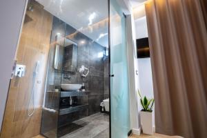 a bathroom with a sink and a glass shower at Blue Bay Hotel in Sarandë +152 photos